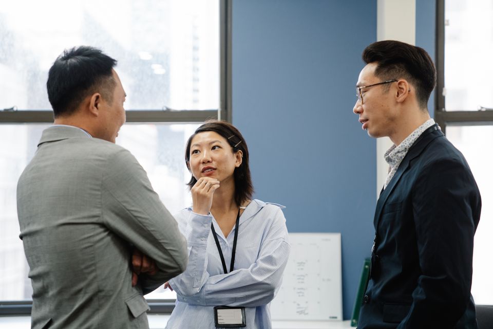 Consultants in conversation during a client meeting